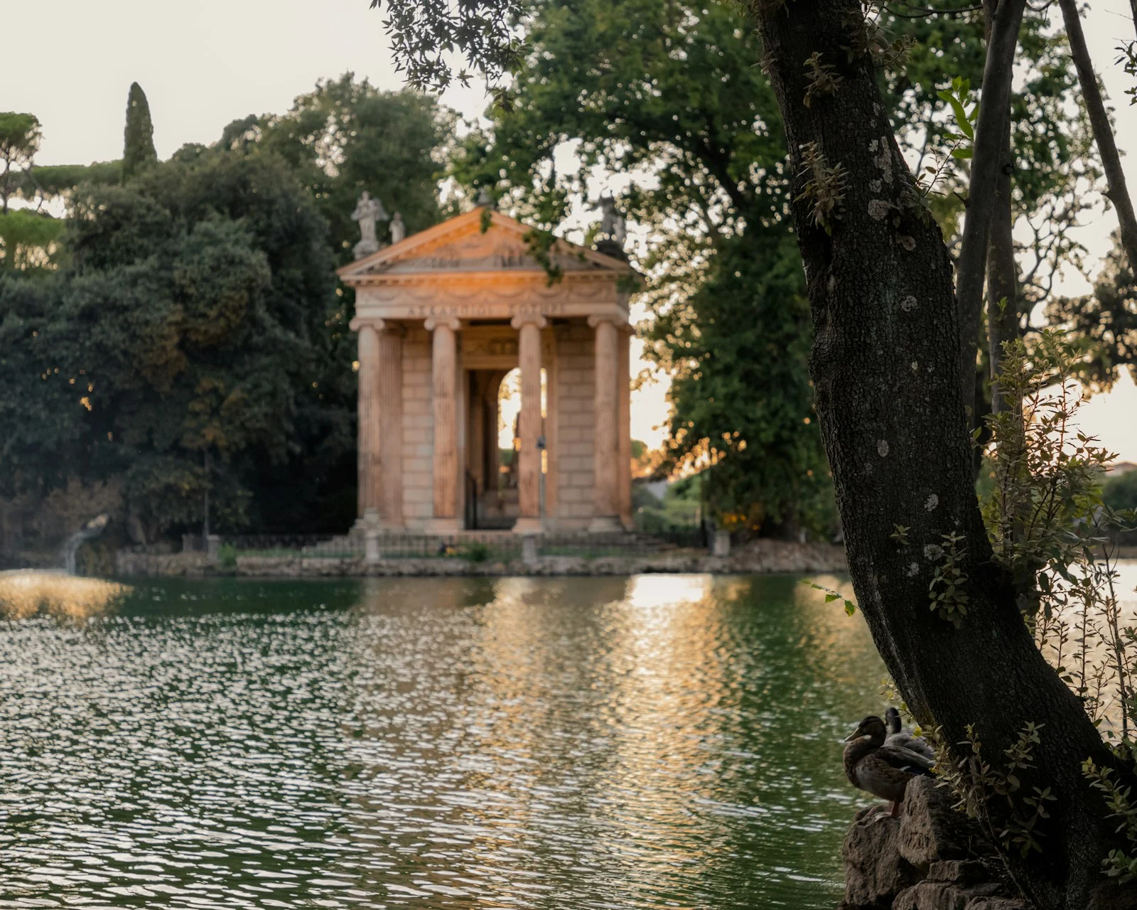 The lake of Villa Borghese with the Temple of Aesculapius at sunset